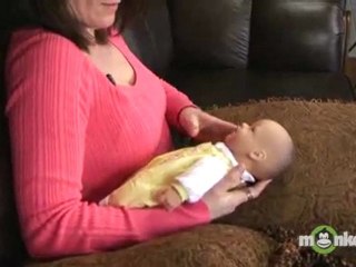 How should I hold my baby when breastfeeding?