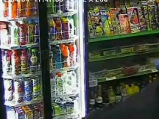 CCTV of shopkeeper fighting gunman with a stick