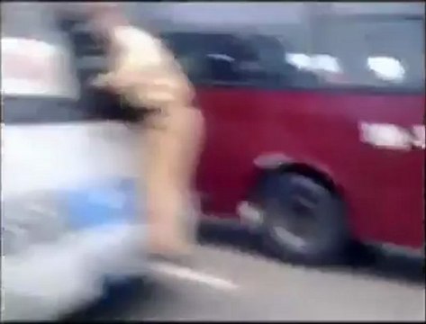 Vietnamese traffic cop clings on to moving bus