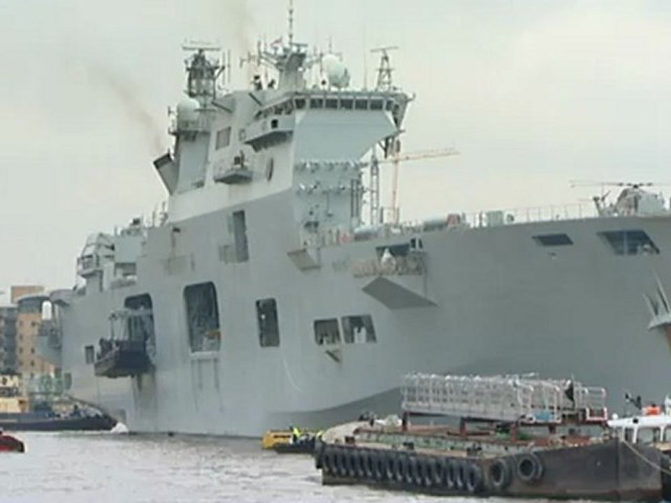 HMS Ocean sails through the Thames Barrier to Greenwich