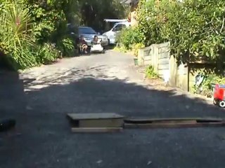 The kids having fun with their bikes in the driveway.