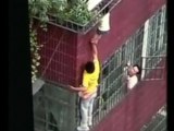 Man Clings to Building to Save Dangling Toddler