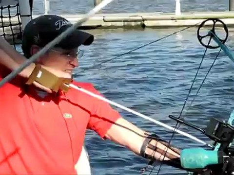 Hunting flying carps with bows and arrows