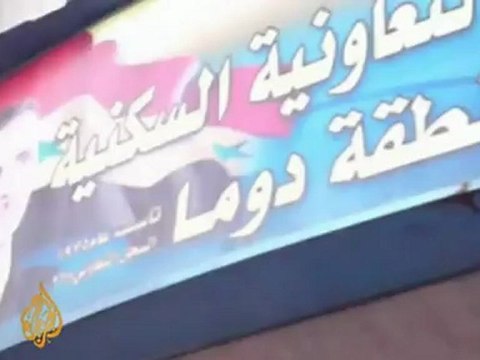 Protesters destroy government symbols in Syria's Douma
