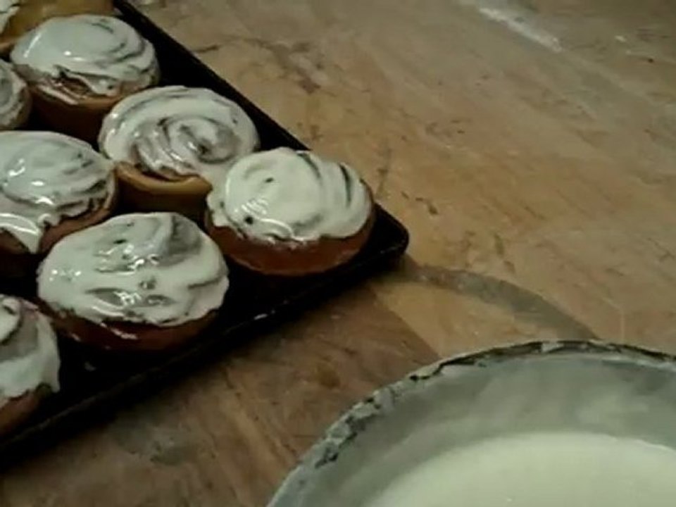 Fresh Cinnamon Rolls  .. Adding icing on the cinnamon rolls.