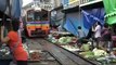 Shoppers bargain over train tracks at Thai market