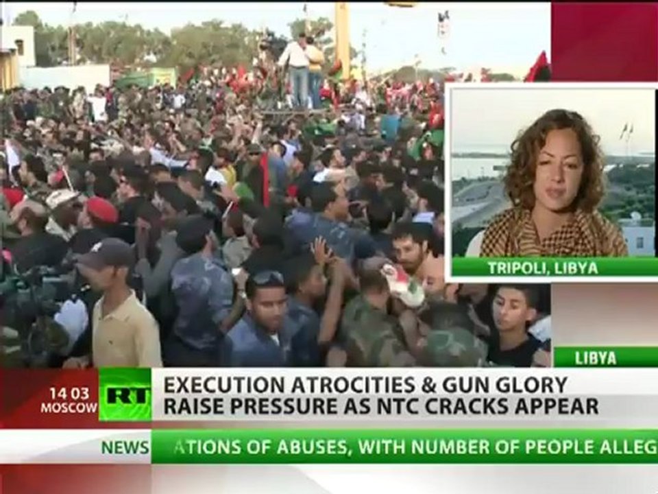 Gun glory in Libya, NTC cracks as Gaddafi buried