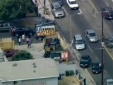 Bank robbers throw cash from car during police chase in LA