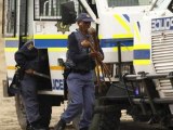 South African police raid striking miners