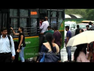 Delhi citizens flock to buses on a suddenly rainy afternoon