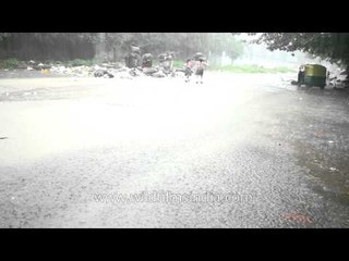 Small kids enjoy the monsoon rain in New Delhi