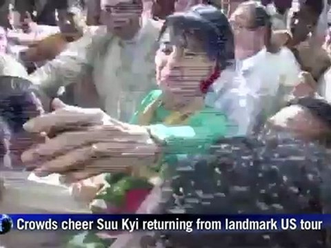 Crowds cheer Suu Kyi on return from landmark US tour