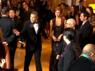 George Clooney receives award at ball.