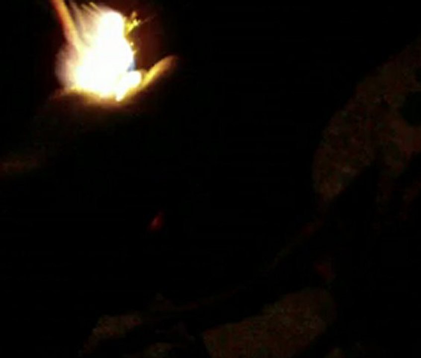 bottle rocket with yellow tiny flare attached on a parachute