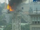 Burning construction crane collapses