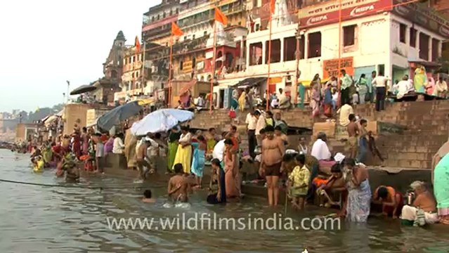 2561.Devotees taking holy dip in river Ganga in Varanasi.mov