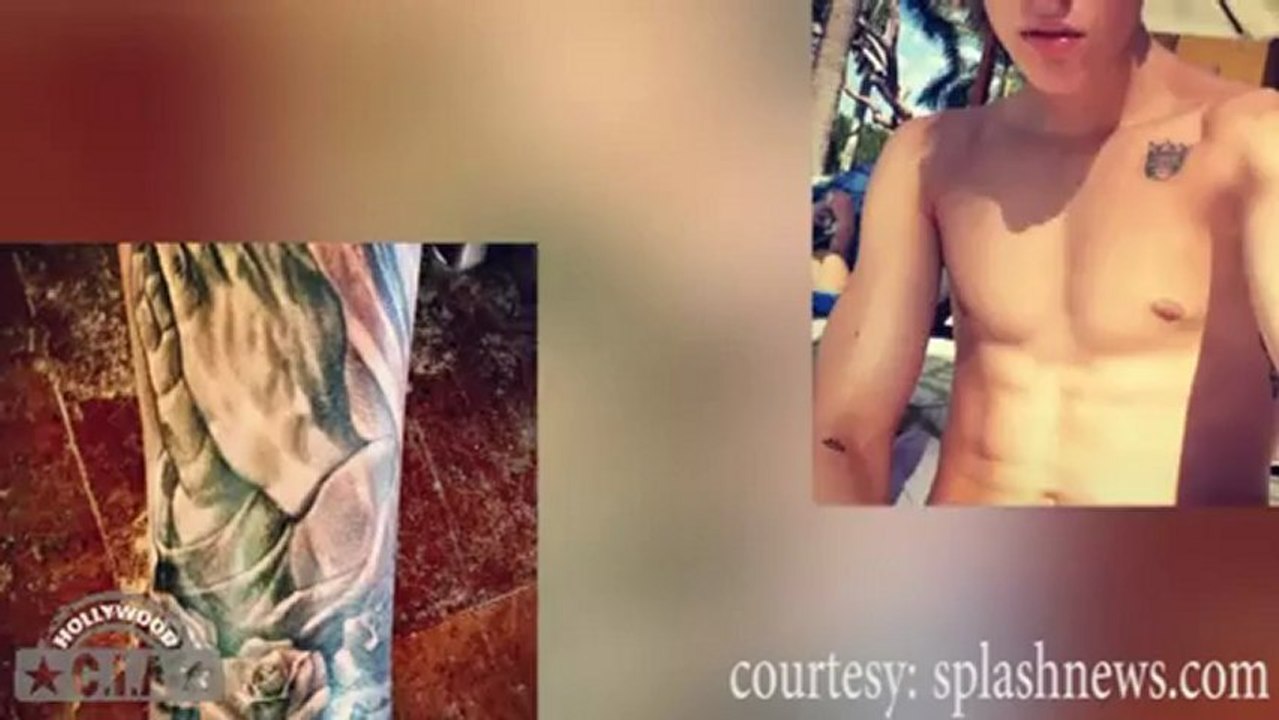 Justin Bieber gets a NEW TATTOO & goes TOPLESS