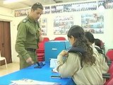 Israeli soldiers cast an early ballot