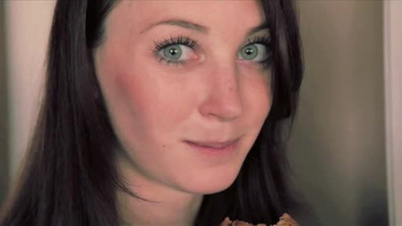 Guy shoves cookie in girl's face