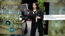 Kim Kardashian couvre son ventre dans une robe et un pantalon en cuir