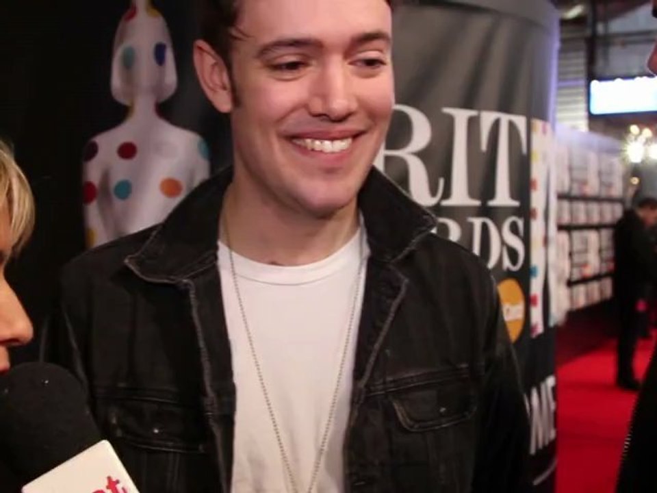 Mumford & Sons' Ben Lovett and Winston Marshall talk to heat on the Brits 2013 red carpet