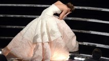 Jennifer Lawrence falls over as she collects Oscar