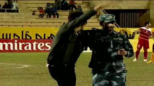 Kuwaiti soldier tackles an Iraqi pitch invader