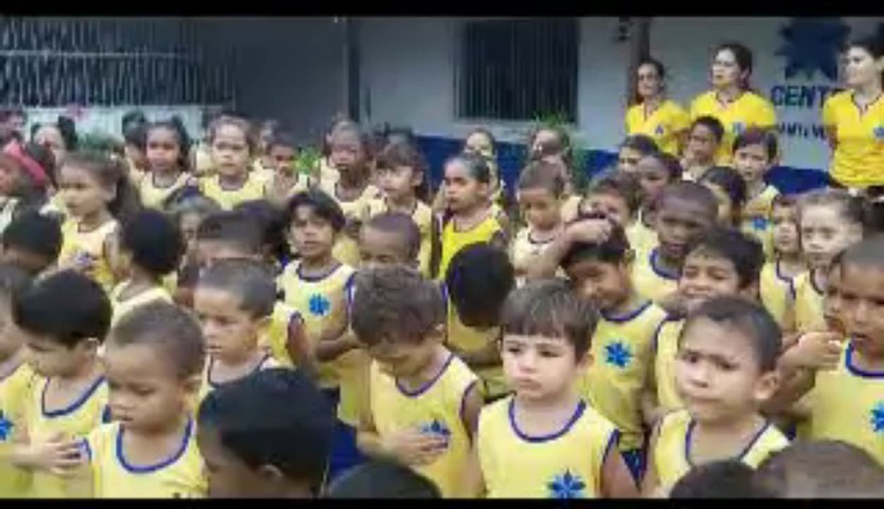 Vicente Telles e as crianças do CEEB cantando o hino