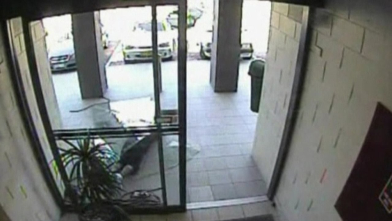 Australian bag-snatcher crashes through glass door