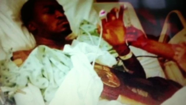 Louisville Kevin ware holding ncaa trophy in hospital