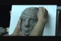 Sculpting a female face in clay