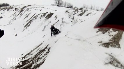 Vintage Snowmobile falls on rider