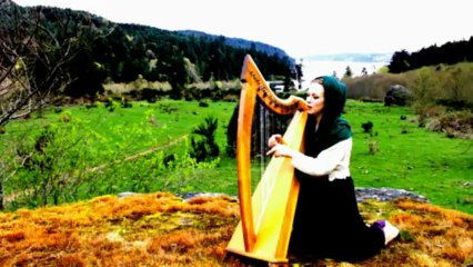 Beautiful Girl Singing and Playing Harp on a Mountain