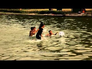 Kids cooling of in the water around India Gate