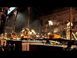 Priests performing evening Ganga aarti on the banks of Varanasi