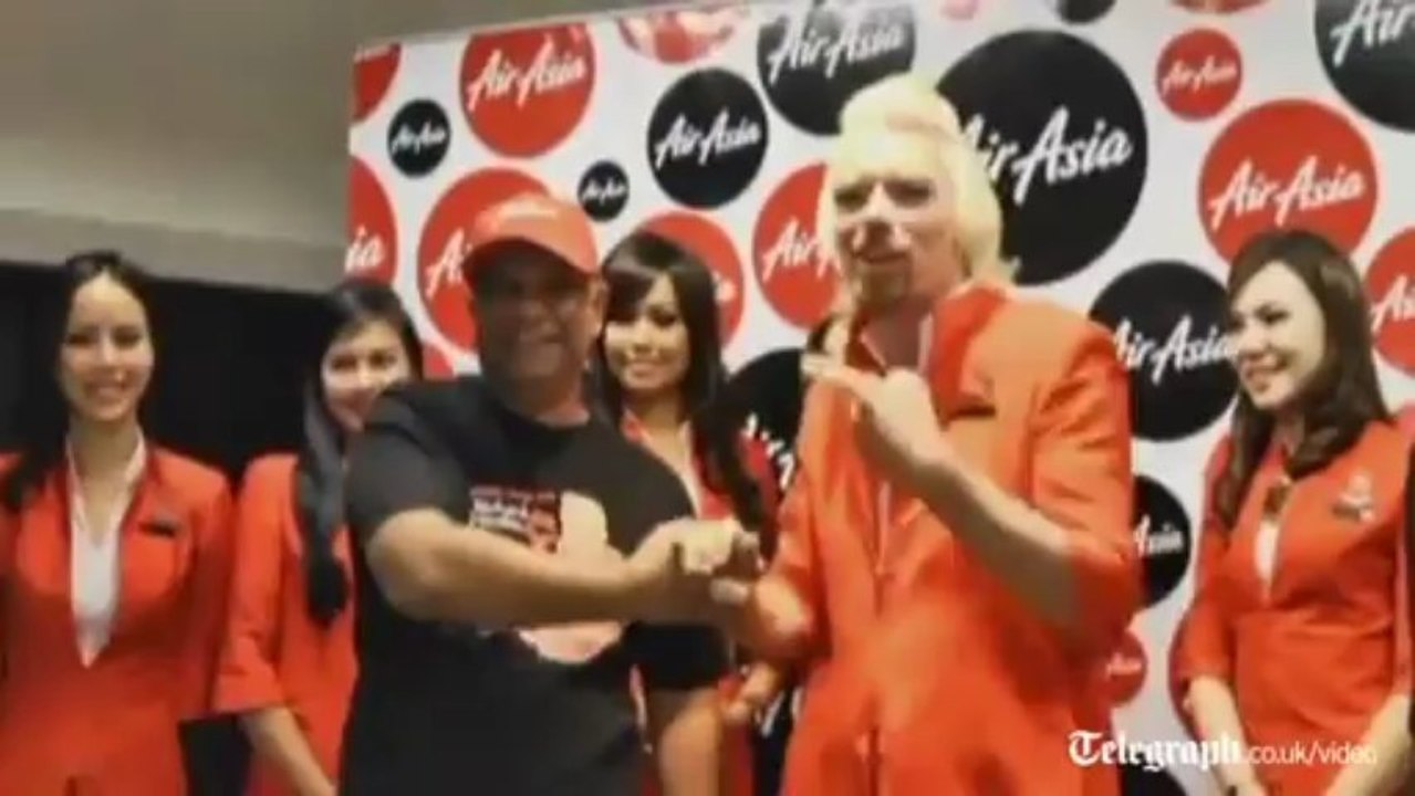 Sir Richard Branson dresses as an sir stewardess after losing bet