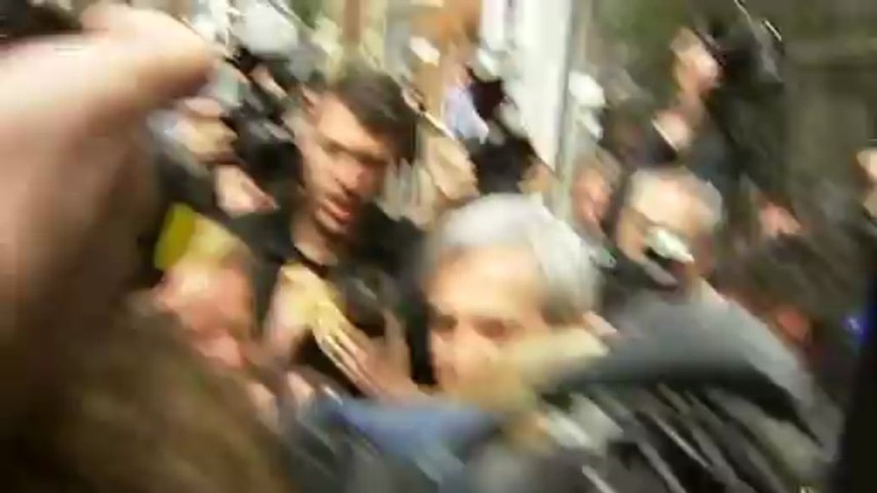 Chris Huhne mobbed by the press as he arrives h...