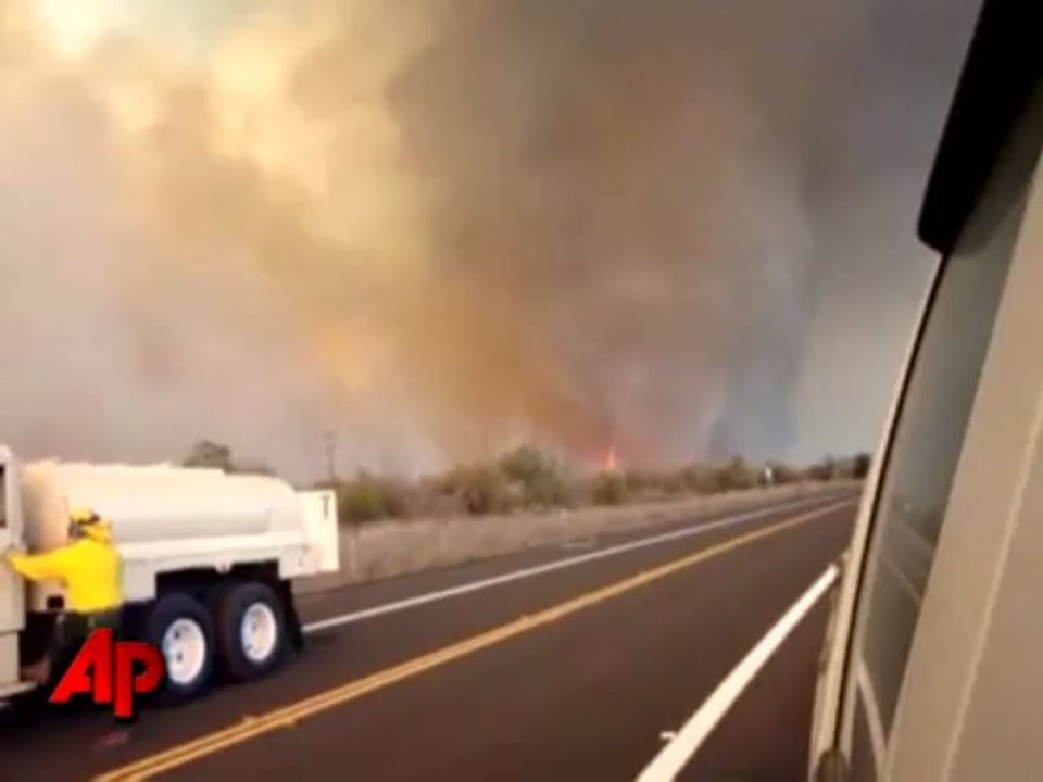 Raw video - strong winds create fire tornado