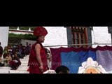 Bhutanese monk unfurling the Thangka on the day of Tsechu festival at Kurjey temple