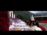 Monks performing the ceremony of unfurling the Thangka outside the monastery in Bhutan