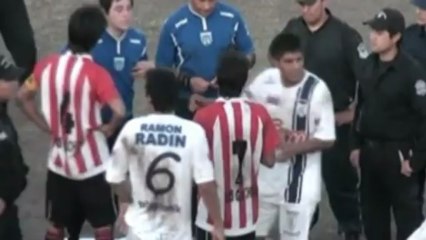 Footballer sent off for throwing dog against a fence
