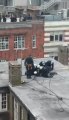 Police tackle G8 protester on rooftop