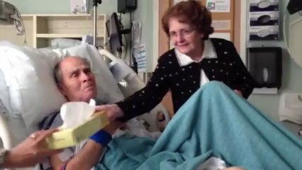 Elderly couple sing to each other in hospital