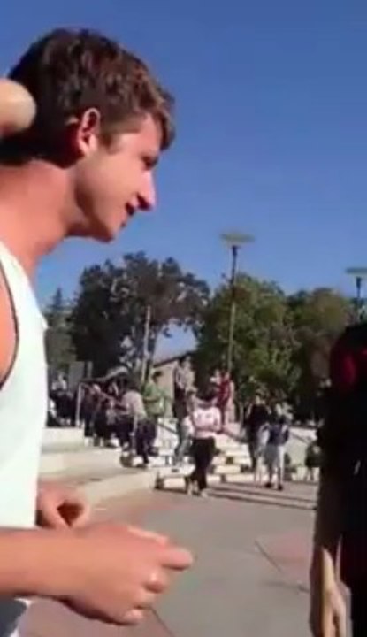 Gay couple kiss in response to anti-gay activist