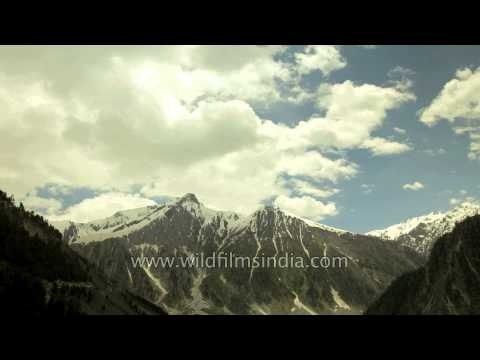 Clouds passing over jagged snow covered Himalayas - Kashmir