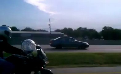 Cat rides motorcycle in a hamster ball