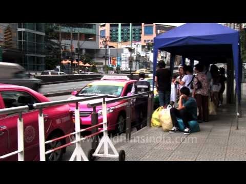 People waiting for pink taxis in Bangkok