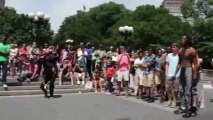 Street performers jump over spectators