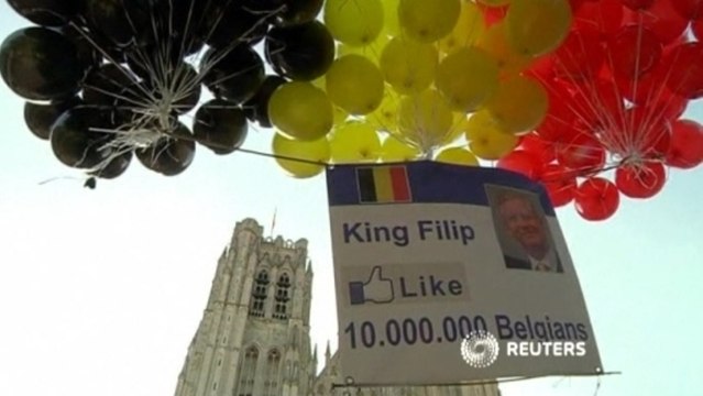 Divided Belgium greets new monarch