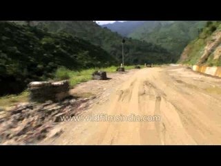 Flood damaged road alongside the river Mandakini